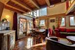 Discover the charm of this rustic property, featuring a warm and inviting interior with exposed wooden beams and a cozy fireplace.