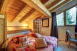 Discover the charm of this cozy bedroom, featuring a stunning wooden ceiling and a warm, inviting atmosphere.