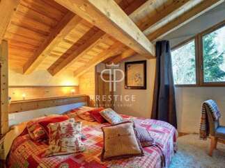 Discover the charm of this cozy bedroom, featuring a stunning wooden ceiling and a warm, inviting atmosphere.