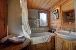 Step into a rustic bathroom retreat, featuring warm wooden accents and a cozy ambiance.