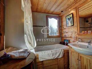 Step into a rustic bathroom retreat, featuring warm wooden accents and a cozy ambiance.