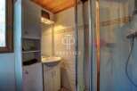 Discover this charming bathroom featuring a sleek shower enclosure and a stylish vanity.