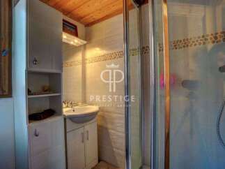 Discover this charming bathroom featuring a sleek shower enclosure and a stylish vanity.