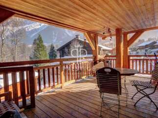 Enjoy breathtaking mountain views from this stunning wooden deck.