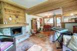 Discover the charm of this cozy home, featuring a stunning stone fireplace and warm wooden accents throughout.