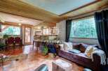 Discover the charm of this cozy property, featuring a warm wooden ceiling and inviting living spaces.