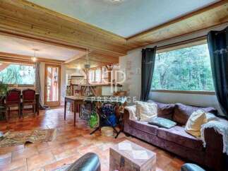 Discover the charm of this cozy property, featuring a warm wooden ceiling and inviting living spaces.