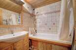 Discover a charming bathroom with a rustic wooden vanity and a pristine white sink.
