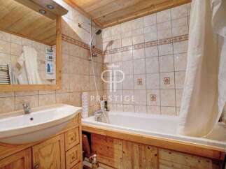 Discover a charming bathroom with a rustic wooden vanity and a pristine white sink.
