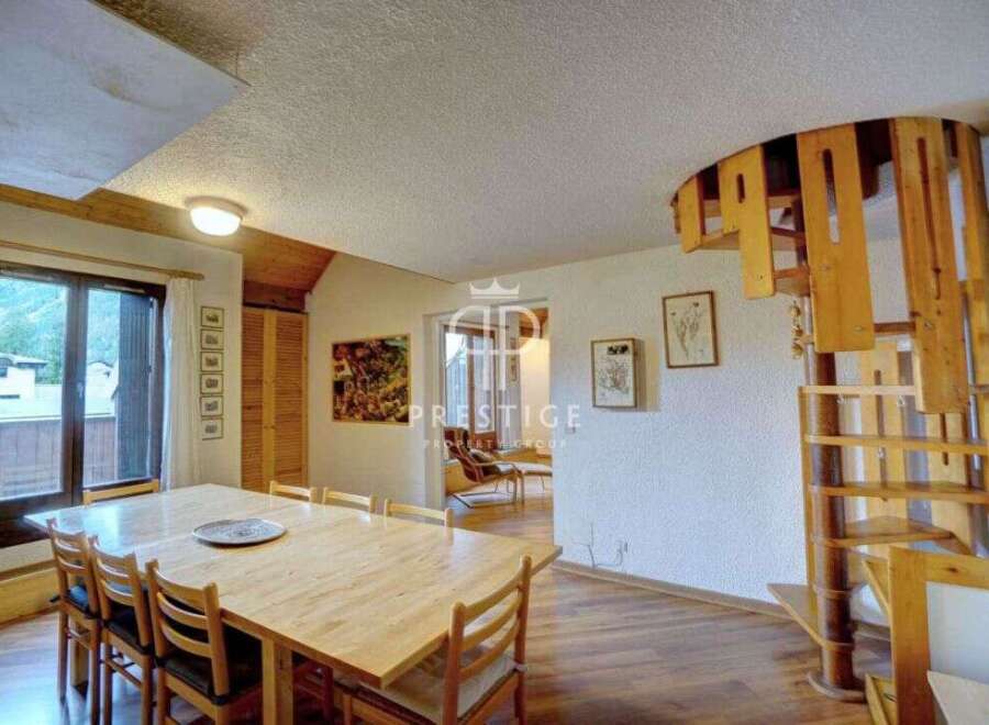 Discover a unique property featuring a stunning wooden spiral staircase, adding a touch of architectural elegance.