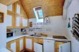 Charming kitchen with wooden cabinets and a unique skylight.