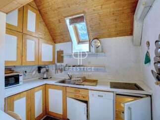 Charming kitchen with wooden cabinets and a unique skylight.