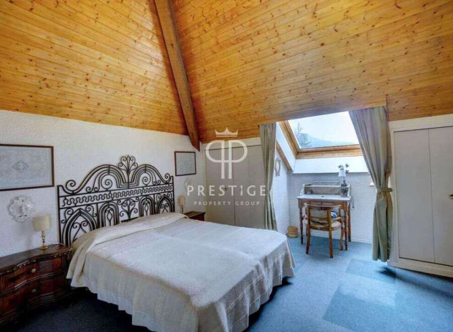 Discover the charm of this unique bedroom with its stunning wooden ceiling and cozy ambiance.