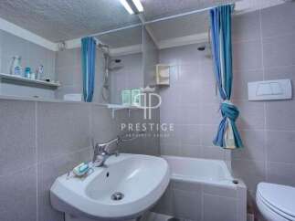 Discover a cozy bathroom with a modern sink and a convenient bathtub.