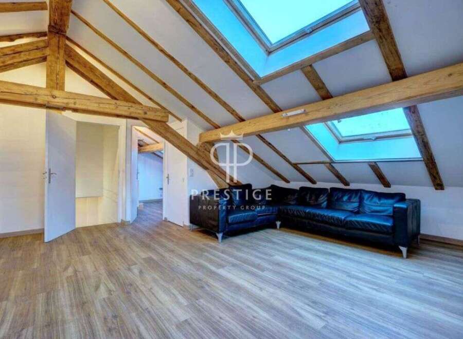 Discover this stunning property featuring a unique architectural design with exposed wooden beams and skylights that flood the space with natural light.