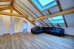 Discover this stunning property featuring a unique architectural design with exposed wooden beams and skylights that flood the space with natural light.