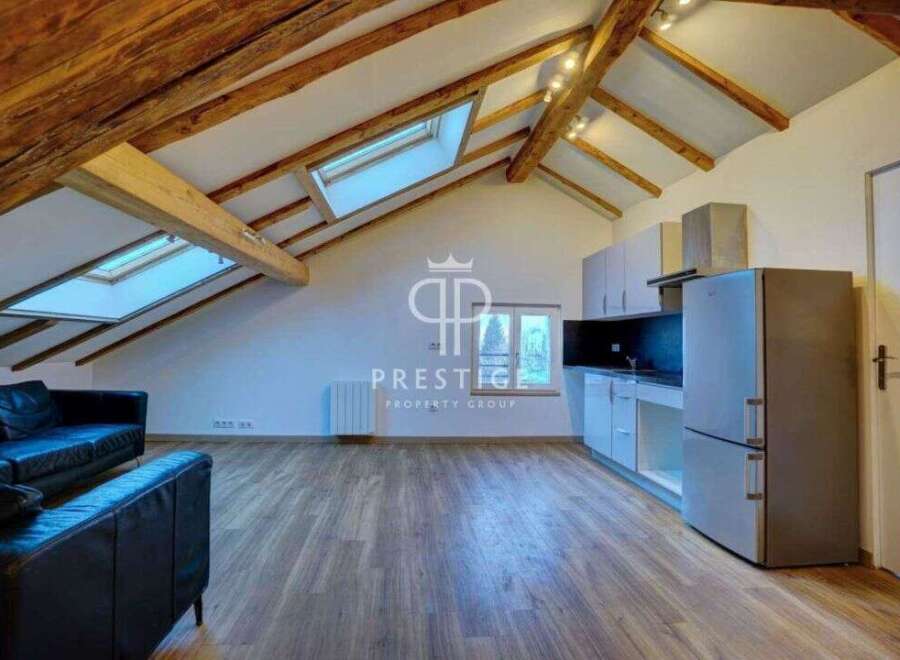 Discover this stunning property featuring a unique architectural design with exposed wooden beams and skylights that flood the space with natural light.