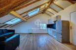 Discover this stunning property featuring a unique architectural design with exposed wooden beams and skylights that flood the space with natural light.