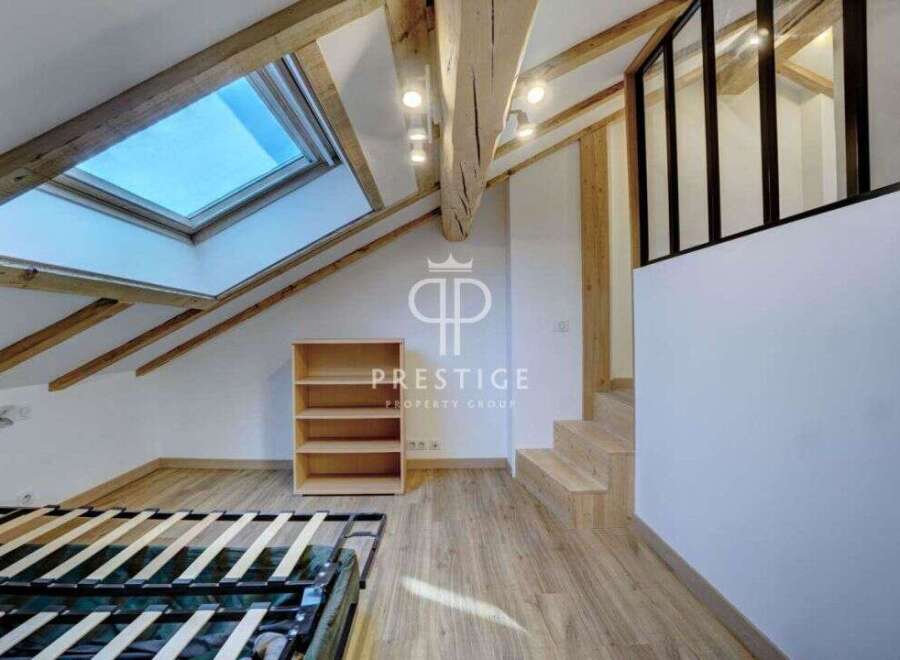 Discover this stunning property featuring a unique architectural design with exposed wooden beams and a skylight that floods the space with natural light.