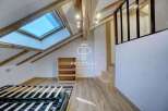 Discover this stunning property featuring a unique architectural design with exposed wooden beams and a skylight that floods the space with natural light.