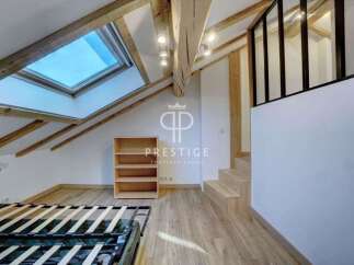 Discover this stunning property featuring a unique architectural design with exposed wooden beams and a skylight that floods the space with natural light.