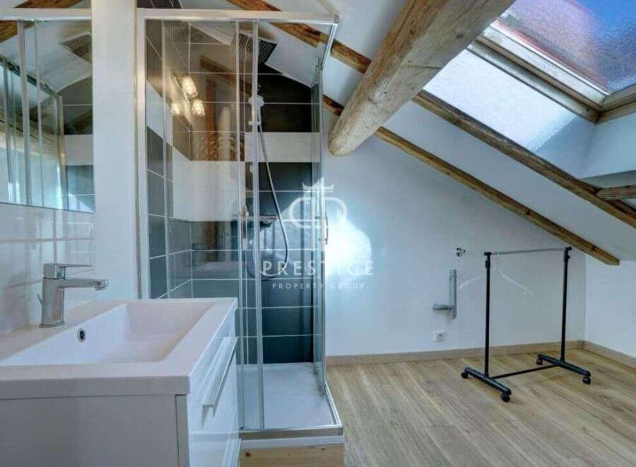 Discover this stunning property featuring a modern bathroom with a sleek glass shower enclosure and a stylish vanity.