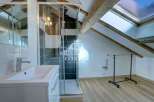 Discover this stunning property featuring a modern bathroom with a sleek glass shower enclosure and a stylish vanity.