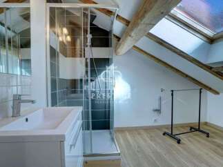Discover this stunning property featuring a modern bathroom with a sleek glass shower enclosure and a stylish vanity.