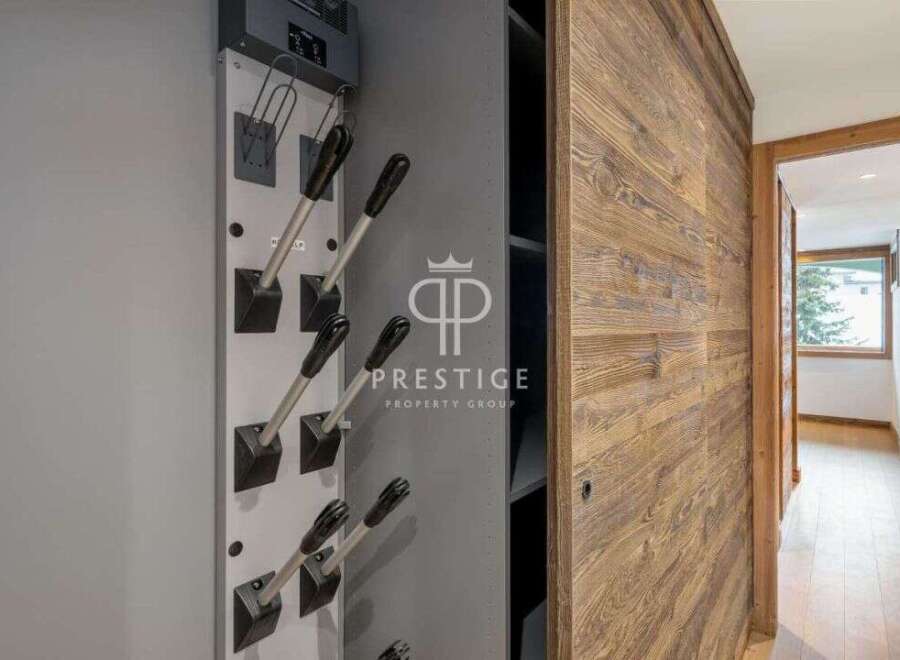 Discover luxury living at its finest! This property boasts stunning wooden accents and a modern ski boot drying rack, perfect for the avid adventurer.
