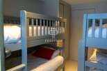 Cozy bunk beds offer a comfortable sleeping arrangement, perfect for families or groups.