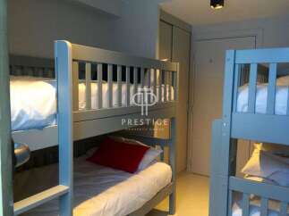 Cozy bunk beds offer a comfortable sleeping arrangement, perfect for families or groups.