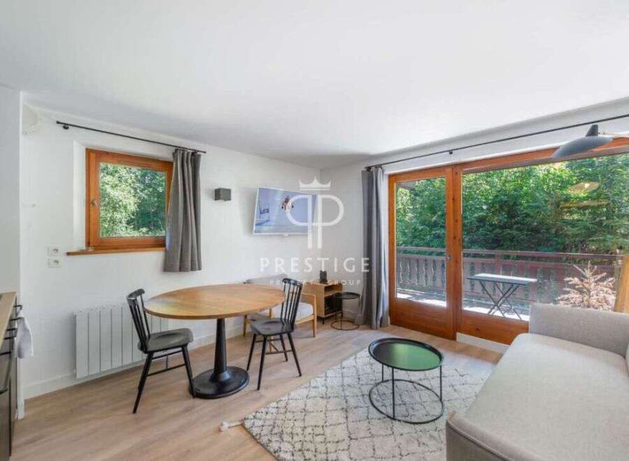 Discover a cozy living space with a charming dining area, perfect for intimate gatherings.