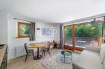 Discover a cozy living space with a charming dining area, perfect for intimate gatherings.
