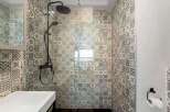 Step into a beautifully designed bathroom featuring stylish patterned tiles.