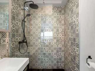 Step into a beautifully designed bathroom featuring stylish patterned tiles.