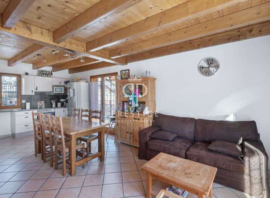 Discover the charm of this inviting home, featuring a warm wooden ceiling and a cozy living space.