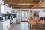 Discover a charming kitchen with a rustic touch, featuring wooden beams and a cozy dining area.