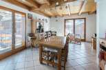 Discover the charm of this property, featuring a cozy dining area with a rustic wooden table and chairs.