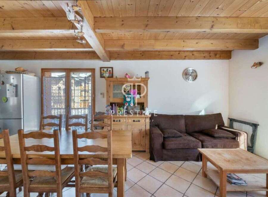 Discover the charm of this inviting property, featuring a warm and rustic interior with exposed wooden beams.