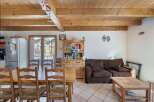 Discover the charm of this inviting property, featuring a warm and rustic interior with exposed wooden beams.