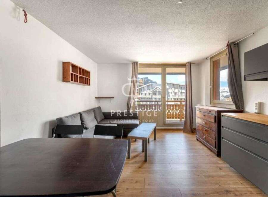 Discover this charming property featuring a cozy living space with a comfortable sofa and a dining area perfect for gatherings.