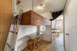 Discover a unique living space with a loft bed, maximizing the room's potential.