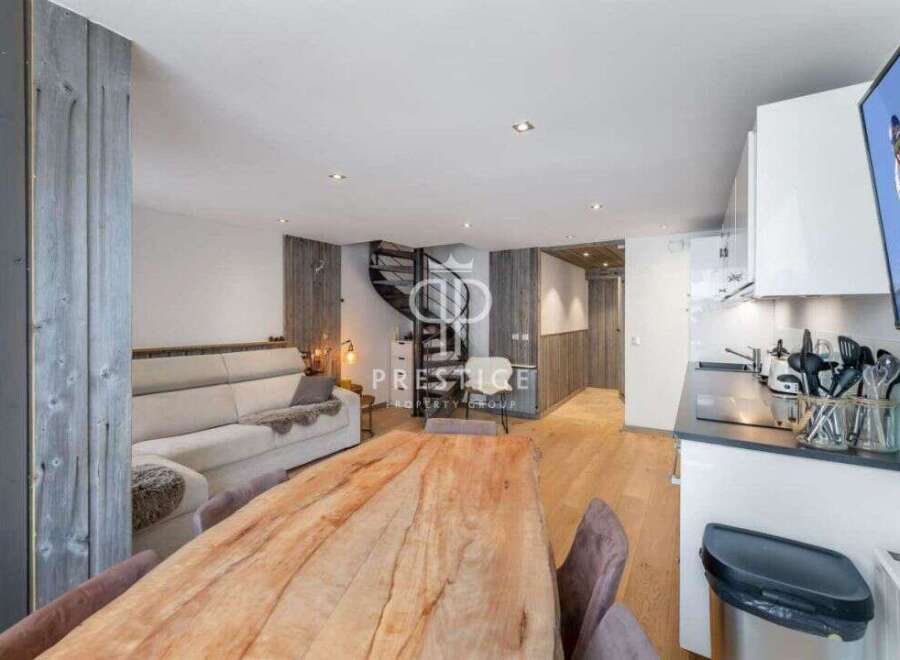 Discover a stunning property featuring a modern kitchen and a cozy living area.