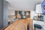 Discover a stunning property featuring a modern kitchen and a cozy living area.