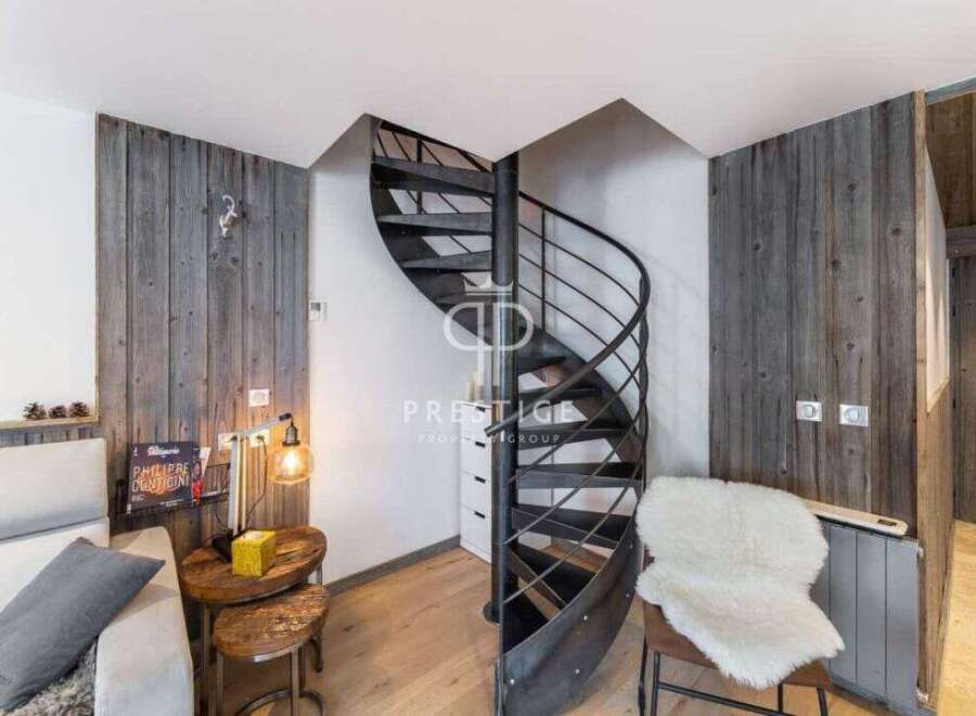Discover a stunning property featuring a unique spiral staircase, adding a touch of modern elegance.