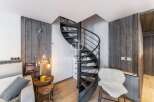 Discover a stunning property featuring a unique spiral staircase, adding a touch of modern elegance.
