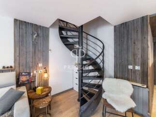 Discover a stunning property featuring a unique spiral staircase, adding a touch of modern elegance.