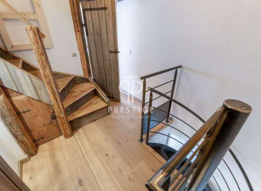 Discover the charm of this property with its unique wooden staircase and inviting entryway.
