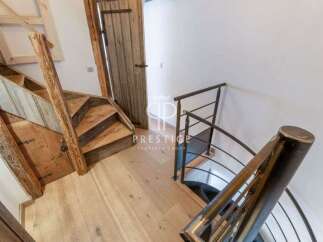 Discover the charm of this property with its unique wooden staircase and inviting entryway.