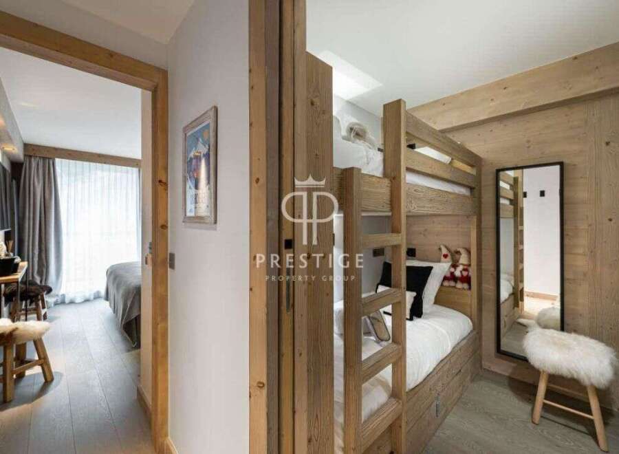 Discover the charm of this cozy bedroom, featuring a unique bunk bed design perfect for families or guests.